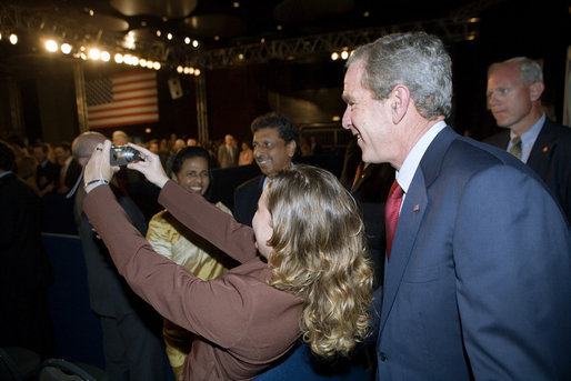President George W. Bush poses for a photo with an audience member after delivering remarks in Brasilia, Brazil, Sunday, Nov. 6, 2005. White House photo by Eric Draper