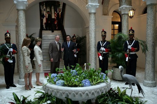 President George W. Bush and Mrs. Bush are welcomed Monday, Nov. 7, 2005, by Panama's President Martin Torrijos and his wife, Vivian, -- and a pet bird -- at the Palacio de Las Garzas in Panama City, Panama. White House photo by Krisanne Johnson