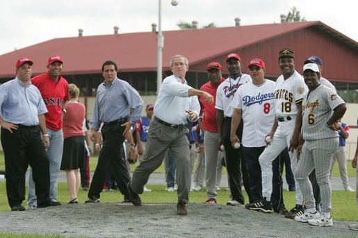 Under the watchful eyes of New York Yankee's Mariano Rivera, second from left, and Panama President Martin Torrijos, third from left, President George W. Bush releases a pitch Monday, Nov. 7, 2005, during a visit with Panamanian youth at Ciudad Del Saber in Panama City, Panama. White House photo by Paul Morse