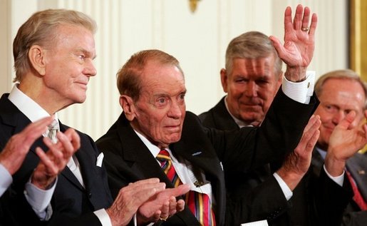 Former Mississippi Congressman and decorated war veteran, G.V. Sonny Montgomery, center, waves as he is introduced, and applauded by his fellow recipients of the 2005 Presidential Medal of Freedom, awarded Wednesday, Nov. 9, 2005 in the East Room. From left to right are, Paul Harvey, Montgomery, General Richard B. Myers and golf legend Jack Nicklaus. White House photo by Shealah Craighead