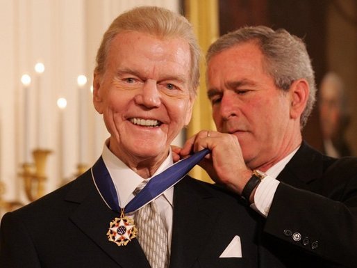 President George W. Bush presents the Presidential Medal of Freedom to legendary radio personality Paul Harvey, one of 14 recipients of the 2005 Presidential Medal of Freedom, awarded Wednesday, Nov. 9, 2005 in the East Room of the White House. White House photo by Shealah Craighead