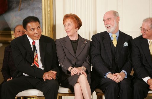 Boxing legend Muhammad Ali glances over to the President during the during the presentation of the Presidential Medal of Freedom in the East Room Wednesday, Nov. 9, 2005. President Bush awards the honor to 14 recipients during the ceremony. White House photo by Paul Morse
