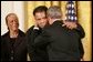 As Mrs. Lonnie Ali looks on, President George W. Bush embraces three-time heavyweight boxing champion of the world Muhammad Ali after presenting him with the Presidential Medal of Freedom Wednesday, Nov. 9, 2005, during ceremonies at the White House. White House photo by Paul Morse