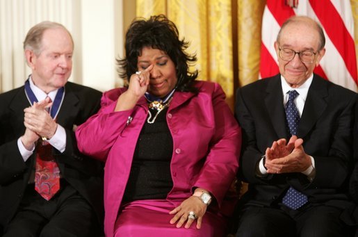 Queen of Soul Aretha Franklin wipes a tear after being honored with the Presidential Medal of Freedom Wednesday, Nov. 9, 2005, during ceremonies at the White House. Looking on are fellow recipients Robert Conquest, left, and Alan Greenspan. White House photo by Paul Morse