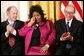 Queen of Soul Aretha Franklin wipes a tear after being honored with the Presidential Medal of Freedom Wednesday, Nov. 9, 2005, during ceremonies at the White House. Looking on are fellow recipients Robert Conquest, left, and Alan Greenspan. White House photo by Paul Morse