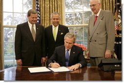 President George W. Bush is backed by U.S. Rep. Tom Latham, R-Iowa, left, U.S. Rep. Henry Bonilla, R-Texas, center, and U.S. Sen. Robert Bennett, R-Utah, Thursday, Nov. 10, 2005 in the Oval Office, as he signs H.R. 2744-Agriculture, Rural Development, Food and Drug Administration, and Related Agencies Appropriations Act, 2006.  White House photo by Eric Draper