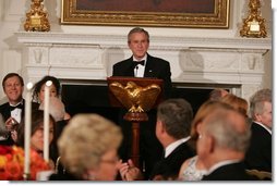 President George W. Bush welcomes guests in the State Dining Room of the White House, Thursday, Nov. 10, 2005, at the dinner celebrating the 40th Anniversary of the National Endowment for the Arts and the National Endowment for the Humanities.  White House photo by Paul Morse