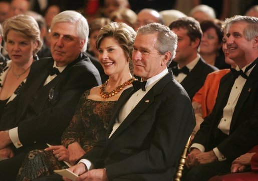 President George W. Bush and Mrs. Laura Bush listen to the evening's entertainment at the White House, Thursday, Nov. 10, 2005, following the dinner celebrating the 40th Anniversary of the National Endowment for the Arts and the National Endowment for the Humanities. White House photo by Paul Morse
