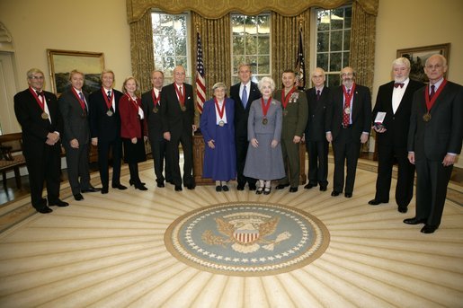 President George W. Bush stands with recipients of the 2005 National Humanities Medals after presentation Thursday, Nov. 10, 2005, in the Oval Office. With the President from left, are: Richard Gilder, history patron; Leigh and Leslie Ken, art historians and appraisers; Mary Ann Glendon, legal scholar; John Lewis Gaddis, historian; Walter Berns, historian; Eva Brann, college professor; Judith Martin, columnist; Col. Matthew Bogdanos, Assistant District Attorney; Bruce Cole, NEH Chairman; Alan Kors, historian; Theodore Crackel, editor, and Lewis Lehrman, history patron. White House photo by Eric Draper