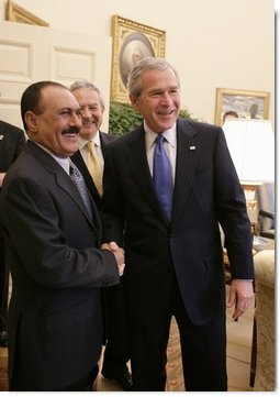 President George W. Bush welcomes Yemen President Ali Abdullah Saleh into the Oval office of the White House, Thursday, Nov. 10, 2005. Interpreter Gamal Helal is seen in background.  White House photo by Eric Draper