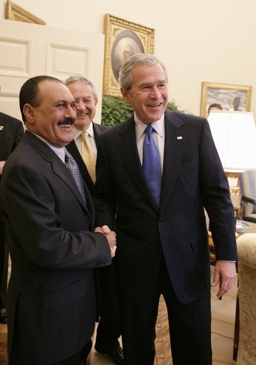 President George W. Bush welcomes Yemen President Ali Abdullah Saleh into the Oval office of the White House, Thursday, Nov. 10, 2005. Interpreter Gamal Helal is seen in background. White House photo by Eric Draper