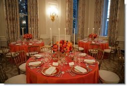 This is a view of the table settings in the State Dining Room, for the Thursday, Nov. 10, 2005 White House dinner, celebrating the National Endowment for the Arts and National Endowment for the Humanities 40th Anniversary. Chosen by Mrs. Laura Bush, the centerpieces are autumnal roses displayed in vermeil vases to compliment the Reagan China.  White House photo by Paul Morse