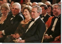 President George W. Bush and Mrs. Laura Bush listen to the evening's entertainment at the White House, Thursday, Nov. 10, 2005, following the dinner celebrating the 40th Anniversary of the National Endowment for the Arts and the National Endowment for the Humanities.  White House photo by Paul Morse