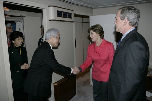 As President Bush looks on, Mrs. Laura Bush shakes hands with Japanese Ambassador to the United States Ryozo Kato and his wife, Hanayo, as the couple greeted the President and First Lady upon their arrival Tuesday, Nov. 15, 2005, to Osaka International Airport. White House photo by Eric Draper