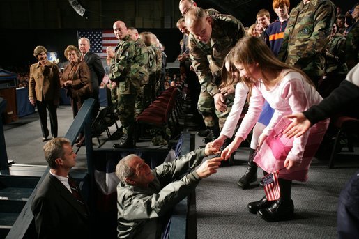 President George W. Bush reaches out to two girls after speaking Monday, Nov. 14, 2005, on the War on Terror at Elmendorf Air Force Base in Anchorage, Alaska. White House photo by Paul Morse