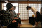 Mrs. Laura Bush accepts a cup of tea from a student in the Tea Ceremony Classroom at Doshisha Girls Junior High School and Senior High School during her visit Wednesday, Nov. 16, 2005, to Kyoto, Japan. With Mrs. Bush are Susanne Schieffer, wife of U.S. Ambassador Thomas Schieffer, and Mrs. Hanayo Kato, wife of Japanese Ambassador Ryozo Kato. White House photo by Shealah Craighead