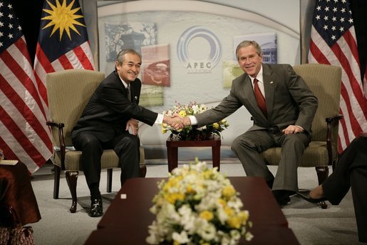 President George W. Bush and Prime Minister Abdullah Ahmad Badawi of Malaysia, exchange handshakes during their meeting Thursday, Nov. 17, 2005, at the Chosun Westin Hotel in Busan, Korea. White House photo by Eric Draper