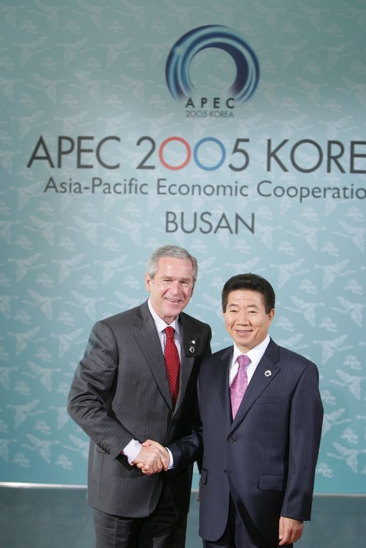 President George W. Bush shakes hands with President Moo Hyun Roh of the Republic of Korea as President Roh welcomes him to the 2005 APEC conference in Busan. White House photo by Paul Morse