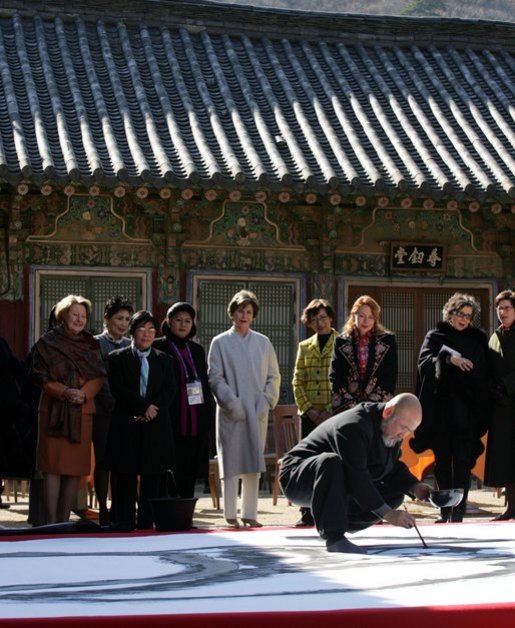 A calligrapher at the Beomeosa Temple in Busan entertains the spouses of APEC leaders Friday, Nov. 18, 2005, during the two-day summit. White House photo by Shealah Craighead