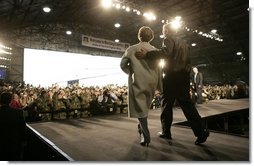 President George W. Bush and Laura Bush enter the Black Cat Hangar at Osan Air Base in Osan, Korea Saturday, Nov. 19, 2005, where the President made remarks to the troops before continuing his Asia tour.  White House photo by Eric Draper