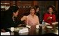 Mrs. Bush tips her teacup to Professor Chung Myung-wha during a discussion Saturday, Nov. 19, 2005, with women leaders in Busan, Korea. White House photo by Shealah Craighead