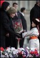 A young boy delivers a bouquet of flowers to Mrs. Bush Monday, Nov. 21, 2005, as she and President Bush joined Mongolia's President and First Lady in ceremonies in Ulaanbaatar welcoming the Bushes to Mongolia. White House photo by Paul Morse