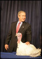 President George W. Bush pets "Marshmallow", the National Thanksgiving Turkey, Tuesday, November 22, 2005, during the Turkey Pardoning Ceremony, held in the Eisenhower Executive Office Building in Washington. White House photo by Shealah Craighead