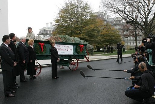 Laura Bush welcomes the arrival of the official White House Christmas tree delivered, Monday, Nov. 28, 2005, on a horse drawn wagon. This year's tree, donated by the Deal Family of Smokey Holler Tree Farm in Laurel Springs, N.C., is the 40th year the National Christmas Tree Growers Association has provided a tree to the White House. White House photo by Shealah Craighead