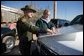 President George W. Bush looks over a map with Deputy Chief Patrol Agent Paul Besson during a tour of the El Paso Sector of the U S -Mexico border region, Tuesday, Nov. 29, 2005. White House photo by Eric Draper