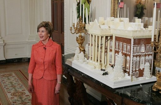 Laura Bush stands before the White House gingerbread house , Wednesday, Nov. 30, 2005, as she answers questions during the press preview of the White House Christmas decorations. White House photo by Shealah Craighead