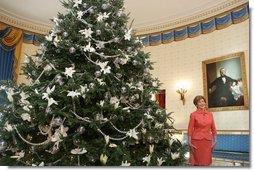 Laura Bush stands next to the Blue Room Christmas tree, Wednesday, Nov. 30, 2005, as she answers questions during the press preview of the White House Christmas decorations.  White House photo by Shealah Craighead