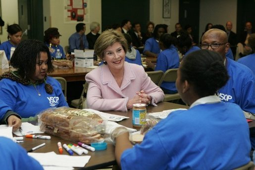 Laura Bush talks with students Wednesday, Nov. 30, 2005 during a visit to the Church of the Epiphany in Washington, as part of her Helping America's Youth initiative, where the students, part of the Youth Service Learning Project, were preparing sandwiches to feed the homeless. White House photo by Shealah Craighead