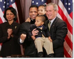 President George W. Bush is seen Thursday, Dec. 1. 2005 in the Eisenhower Executuive Office Building in Washington, as he poses for photos with U.S. Rep. Jesse Jackson Jr. and his children, Jesse Jackson III and Jessica, following the signing of H.R. 4145, to Direct the Joint Committee on the Library to Obtain a Statue of Rosa Parks, which will be placed in the US Capitol's National Statuary Hall. U.S. Secretary of State Condoleezza Rice is seen at left.  White House photo by Paul Morse