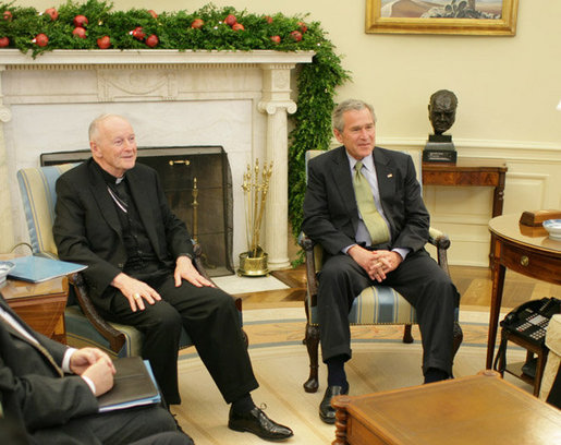 President George W. Bush meets with Theodore Cardinal McCarrick, Archbishop of Washington, Thursday, Dec. 1, 2005, in the Oval Office at the White House. White House photo by Paul Morse