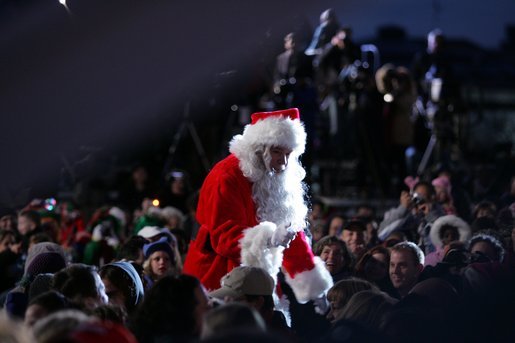 Santa goes into the audience to sing a song, Thursday evening, Dec. 1, 2005, during the Pageant of Peace and the lighting of the National Christmas Tree on the Ellipse in Washington. White House photo by Paul Morse