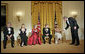 President George W. Bush congratulates Tina Turner during a reception for the Kennedy Center Honors in the East Room of the White House Sunday, Dec. 4, 2005. From left, the honorees are singer Tony Bennett, dancer Suzanne Farrell, actress Julie Harris, actor Robert Redford and singer Tina Turner. White House photo by Eric Draper