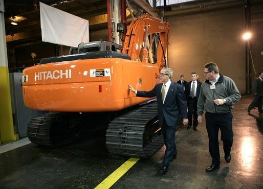 President George W. Bush tours the John Deere-Hitachi excavator assembly line, Monday, Dec. 5, 2005 with operations manager Ron Morrison, prior to his remarks on the economy and tax relief to an audience in Kernersville, N.C. White House photo by Eric Draper