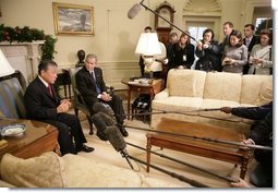 President George W. Bush listens as Dr. Lee Jong-wook, the Director-General of the World Health Organization, answers reporters questions, Tuesday, Dec. 6, 2005 in the Oval Office.  White House photo by Eric Draper
