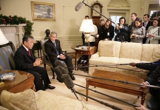President George W. Bush listens as Dr. Lee Jong-wook, the Director-General of the World Health Organization, answers reporters questions, Tuesday, Dec. 6, 2005 in the Oval Office. White House photo by Eric Draper