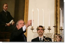 President George W. Bush participates in the Menorah lighting at the White House with Rabbi Joshua Skoff and members of the Skoff family, Tuesday, Dec. 6, 2005, prior to the annual White House Hanukkah reception. White House photo by Kimberlee Hewitt