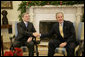 President George W. Bush and Austria Chancellor Wolfgang Schuessel exchange handshakes during the Chancellor's visit Thursday, Dec. 8, 2005, to the White House.  White House photo by Eric Draper