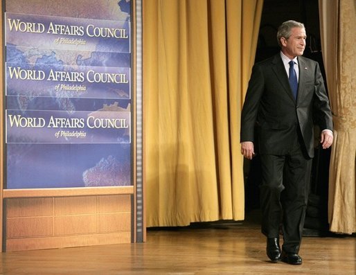 President George W. Bush walks onto the stage during his introduction before delivering remarks on the War on Terror in front of members of the World Affairs Council of Philadelphia, Monday, Dec. 12, 2005. White House photo by Eric Draper