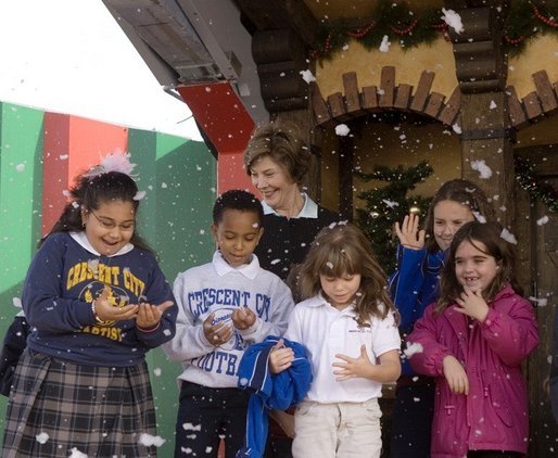 Laura Bush and children from New Orleans neighborhoods react to a downpour of fake snow flakes, Monday Dec. 12, 2005 at the Celebration Church in Metairie, La., during a Toys for Tots event. White House photo by Shealah Craighead