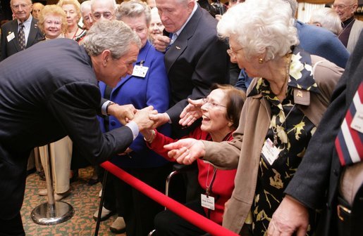 President George W. Bush bends to meet Jean Tessier of Tyson's Corner, Va., during his visit Tuesday, Dec. 13, 2005, to the Medicare Prescription Drug Educational and Enrollment Event at the Greenspring Village Retirement Community in Springfield, Va. White House photo by Paul Morse