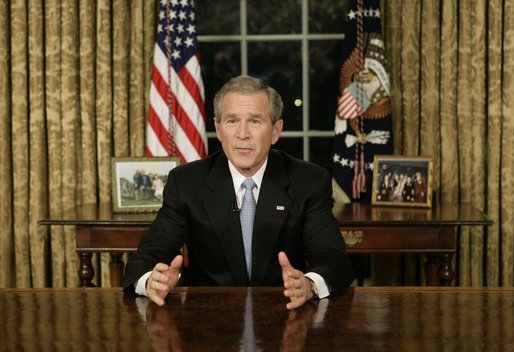 President George W. Bush addresses the nation Sunday, Dec. 18, 2005, from the Oval Office of the White House. Said the President, "Next week, Americans will gather to celebrate Christmas and Hanukkah. Many families will be praying for loved ones spending this season far from home in Iraq, Afghanistan or other dangerous places. Our Nation joins in those prayers. We pray for the safety and strength of our troops." White House photo by Eric Draper
