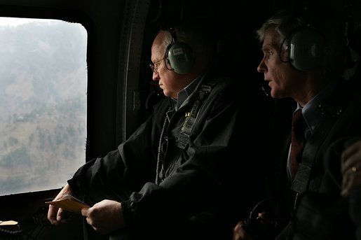 Vice President Dick Cheney and US Ambassador to Pakistan Ryan Crocker survey the devastation of Pakistan's earthquake zone Tuesday, December 20, 2005. At the peak of initial relief efforts, the U.S. had more than 1,200 personnel and 24 helicopters in the affected areas. American troops have flown more than 2,600 helicopter flights to deliver nearly 12 million pounds of relief supplies while US personnel have cared for more than 11,000 Pakistanis and supplied critical engineering support. White House photo by David Bohrer