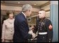 President George W. Bush shakes the hand of Marine Cpl. Andrew L. Tinsley of Annapolis, Md., Wednesday, Dec. 21, 2005, after Cpl Tinsley was presented the Purple Heart during a visit by the President and Laura Bush to the National Naval Medical Center in Bethesda, Md. White House photo by Paul Morse