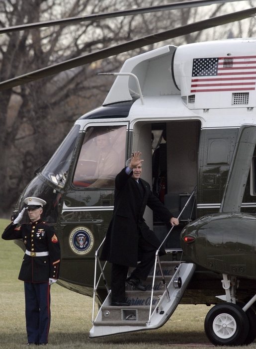 President George W. Bush waves to onlookers as he boards Marine One on the South Lawn Thursday, Dec. 22, 2005, en route to Camp David, where he and family will enjoy the Christmas holiday. White House photo by Kimberlee Hewitt