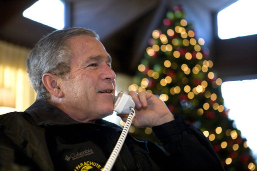 President George W. Bush speaks to members of the United States Armed Forces during Christmas Eve phone calls at Camp David, Saturday, Dec. 24, 2005. White House photo by Eric Draper