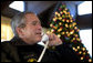 President George W. Bush speaks to members of the United States Armed Forces during Christmas Eve phone calls at Camp David, Saturday, Dec. 24, 2005.  White House photo by Eric Draper